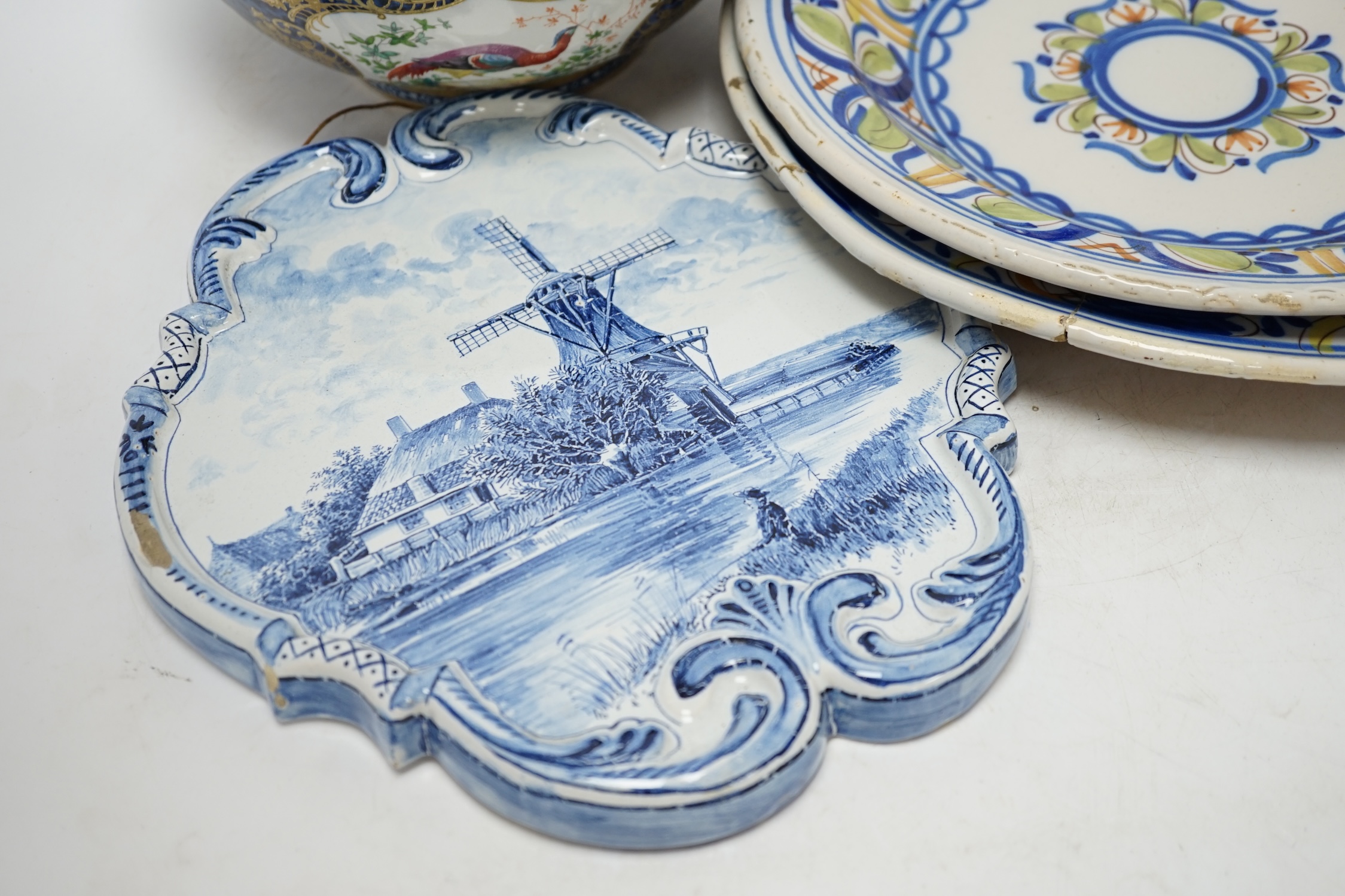 A Delft blue and white plaque, two continental tin-glazed dishes, one signed V.M.D, and a Booths scale-blue bowl, largest 35cm in diameter. Condition - largest dish poor, others fair